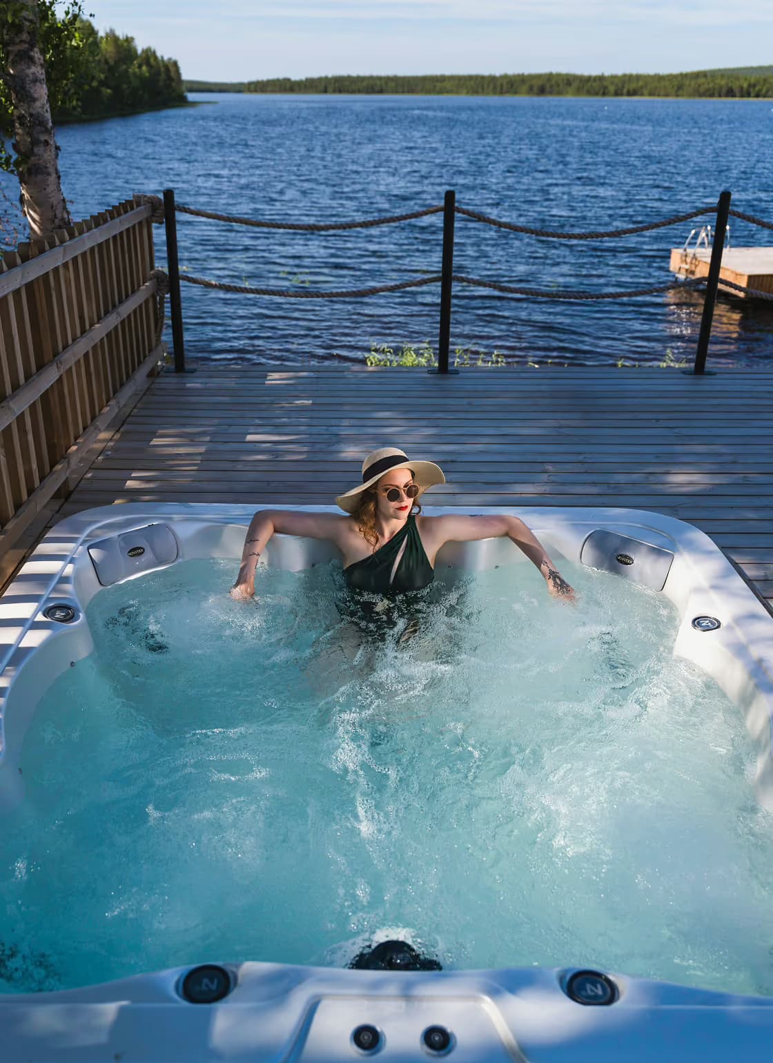 Woman enjoying a lakeview jaccuzi in summer at Aito Resort