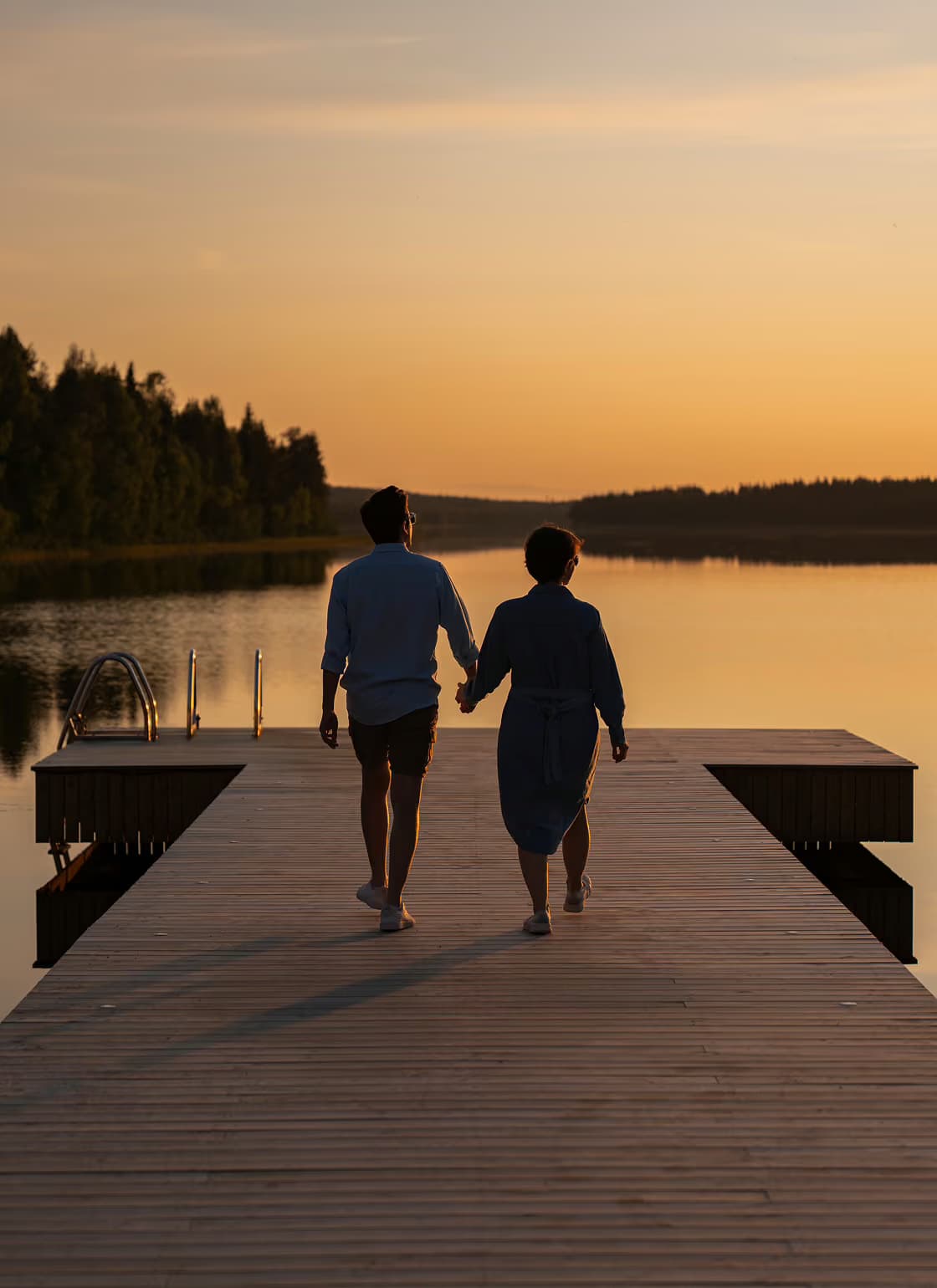 Couple walking on a pier at Lake Palojärvi