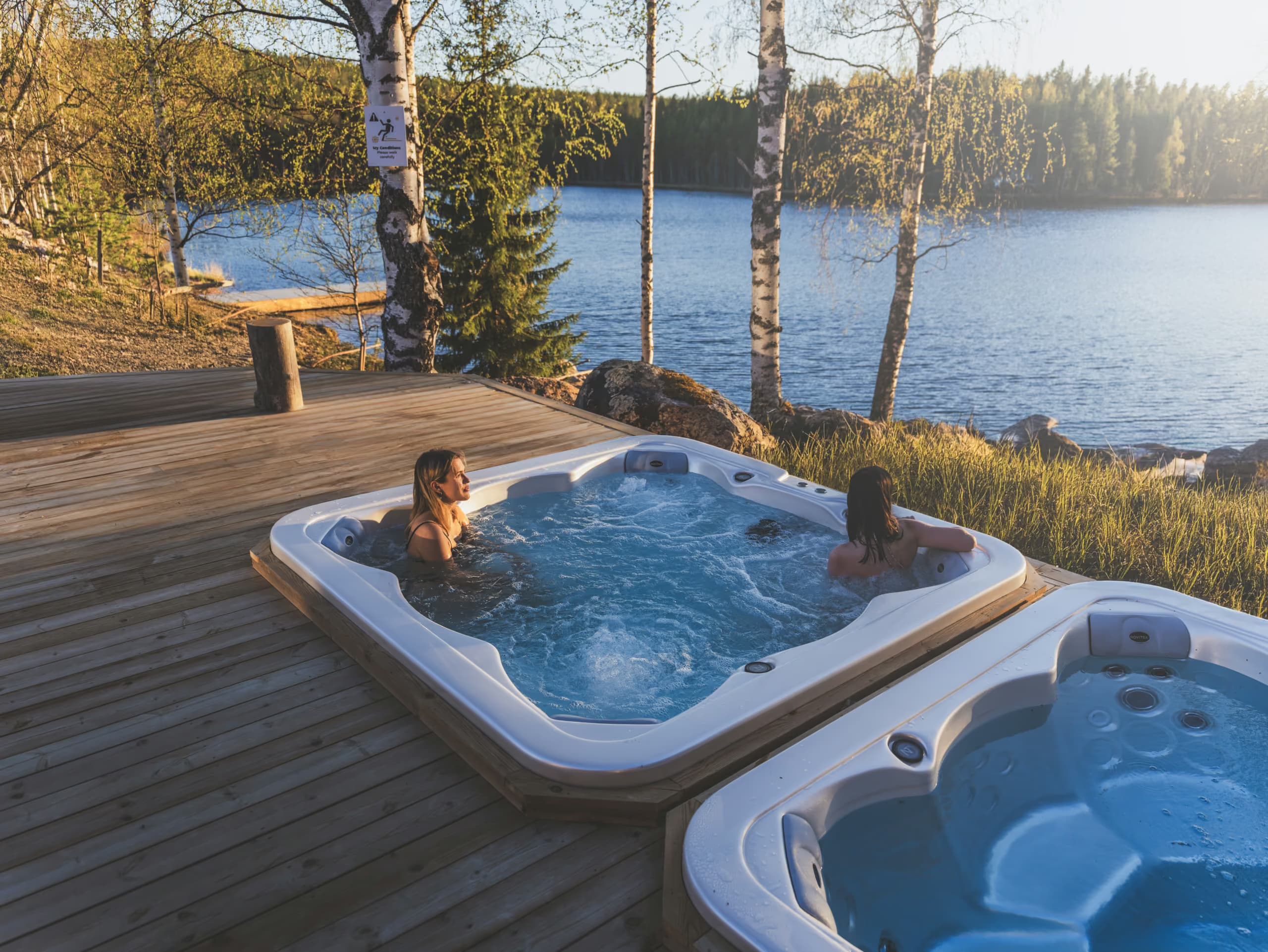 Women enjoying a lakeview jaccuzi in summer at Aito Resort