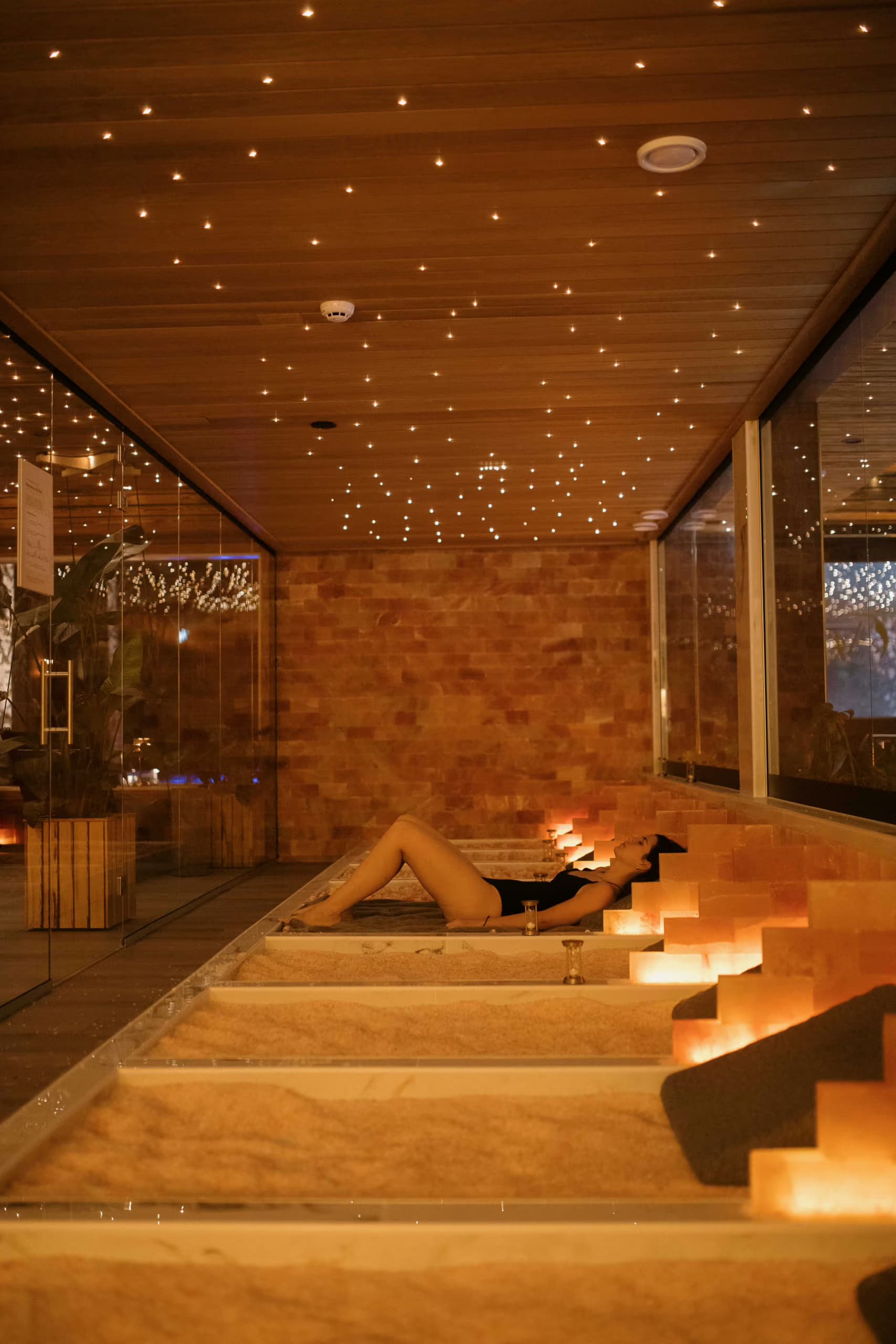 Woman laying down on a Himalayan salt bed at Aito Resort