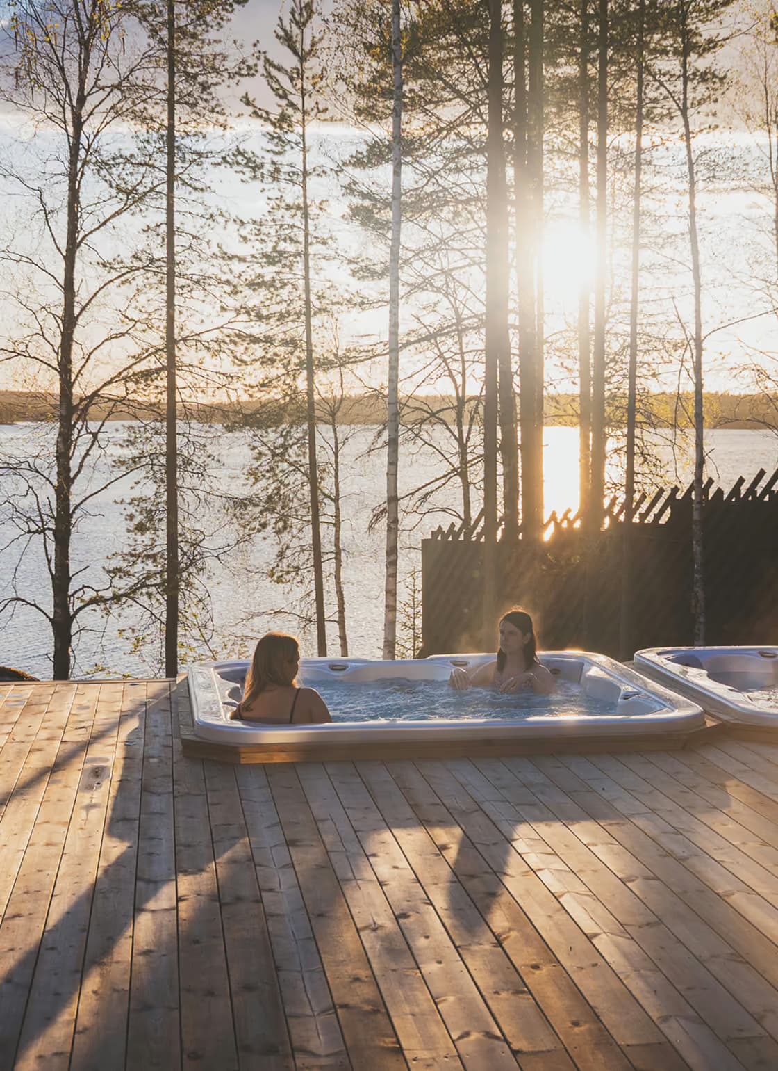 Women enjoying a lakeview jaccuzi in summer at Aito Resort