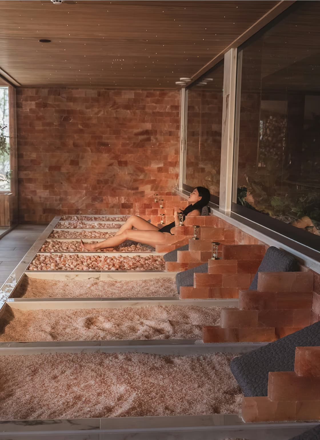 Woman sitting on a Himalayan salt bed at Aito Resort