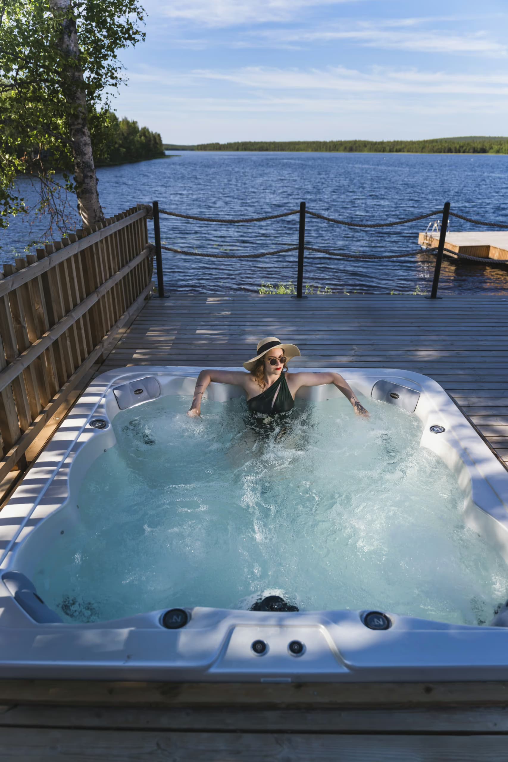 Woman enjoying a lakeview jaccuzi in summer at Aito Resort