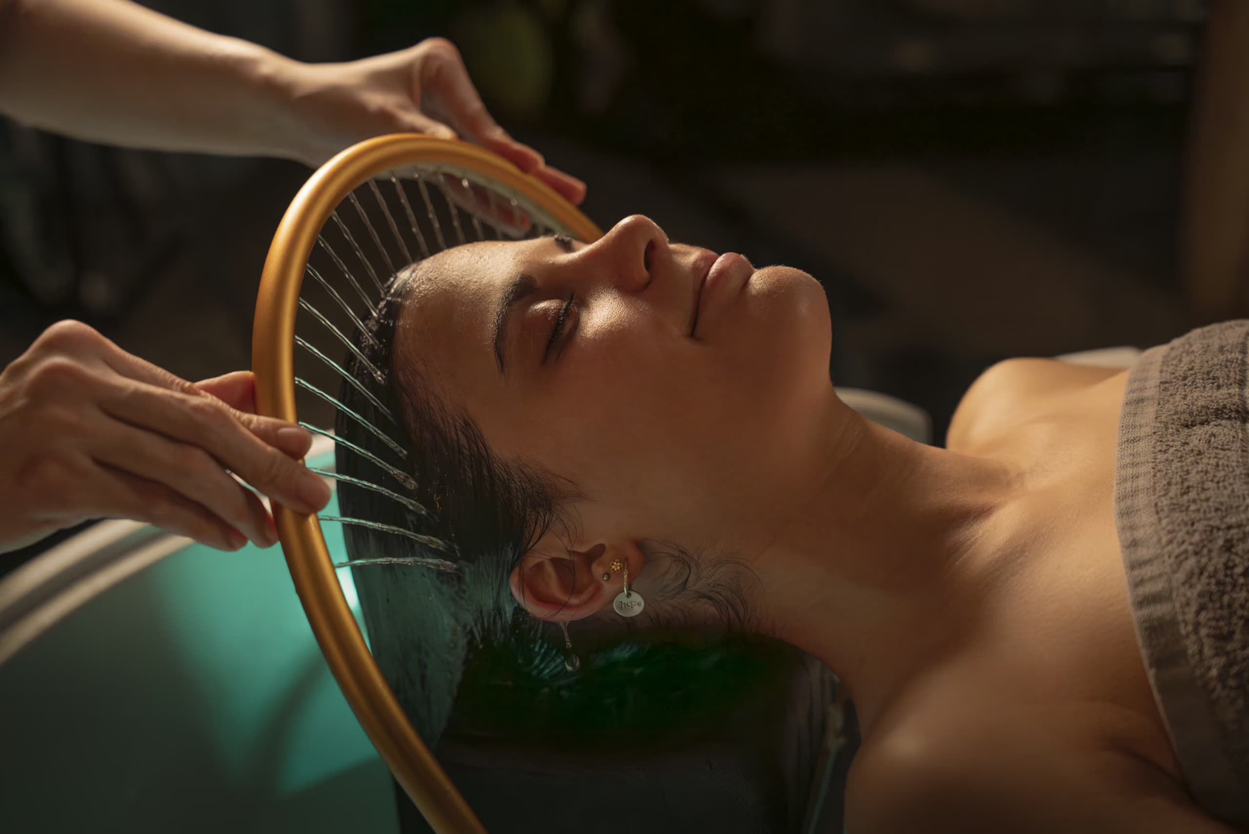 Woman receiving hair therapy at Aito Resort’s Signature Treatment Centre