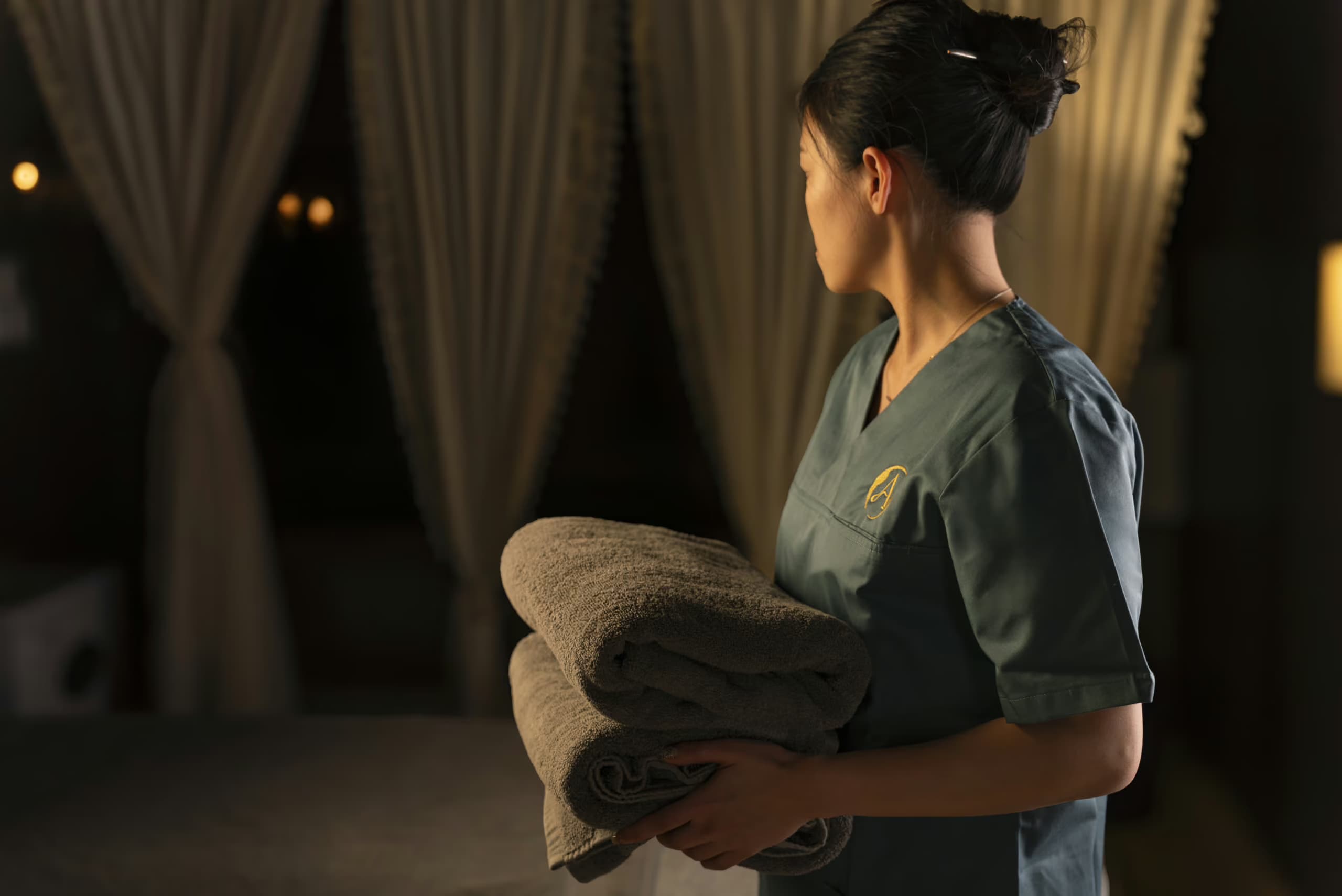 Spa Therapist holding towels at Aito Resort’s Signature Treatment Centre