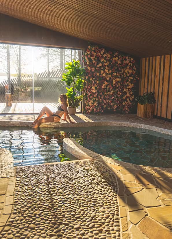 A guest sitting in the Arctic Spa Centre's hot spring pool