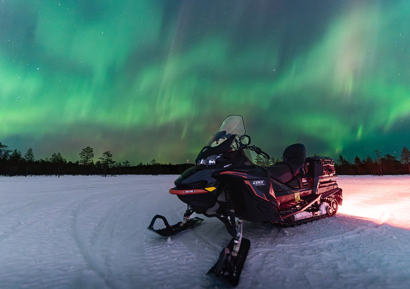 Northern lights and snowmobiles