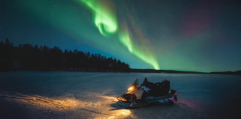 Northern lights and snowmobiles