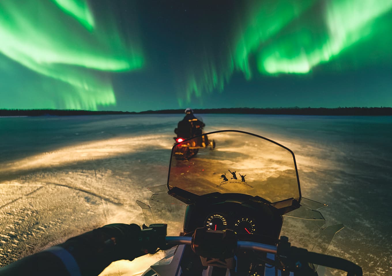 Northern lights and snowmobiles