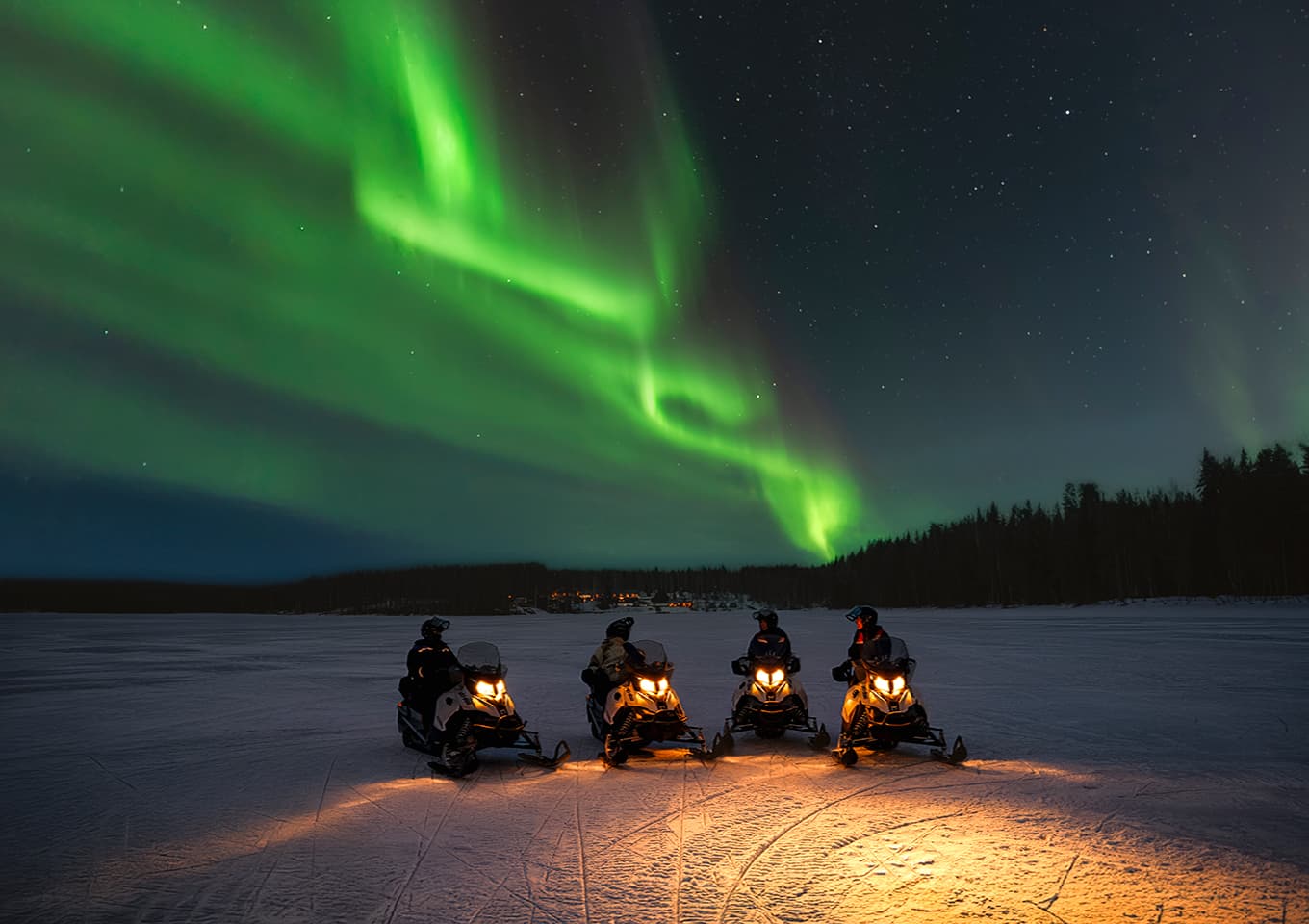 Northern lights and snowmobiles