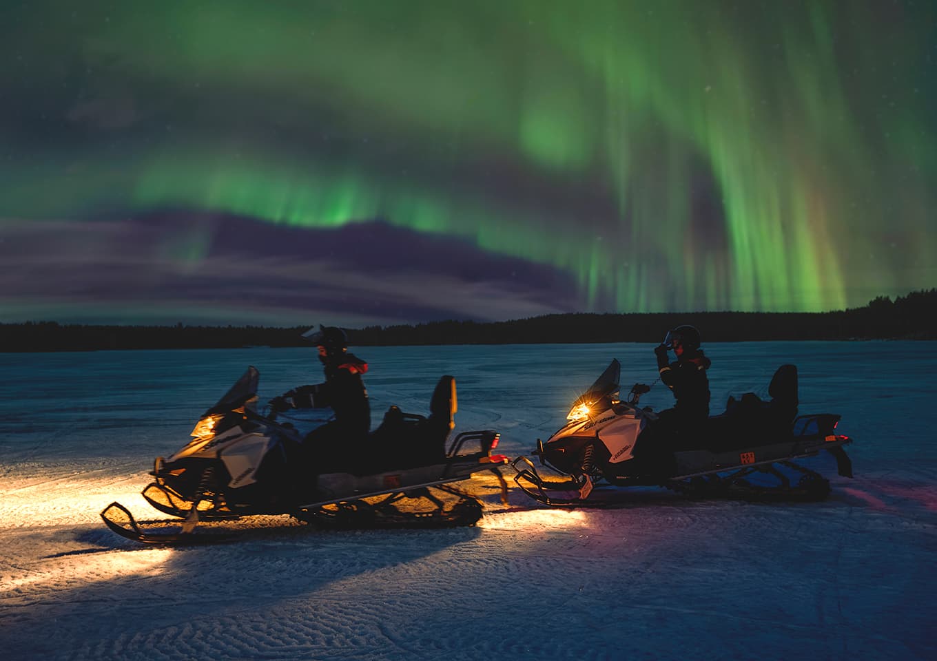 Northern lights and snowmobiles